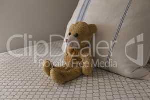 Teddy bear on a bed in bedroom at home