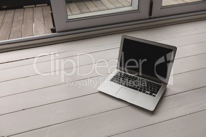 Laptop kept on a wooden surface