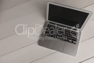 High angle view of laptop kept on a wooden surface