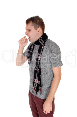 Young man standing and coughing with hand on mouth