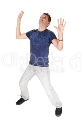 Scared young man with his hands up in the air