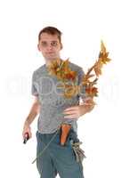 Young man holding on autumn trees and cutter