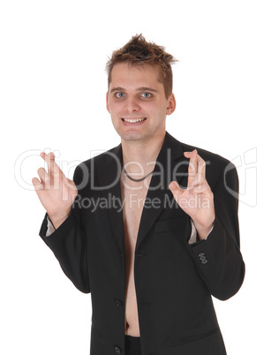 Man with out shirt standing with fingers crossed