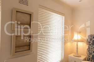 Wall frames near window blinds at home