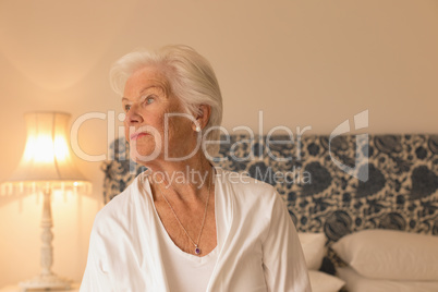 Senior woman relaxing in bedroom at home