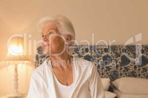 Senior woman relaxing in bedroom at home