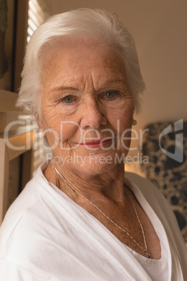 Happy senior woman relaxing in bedroom at home