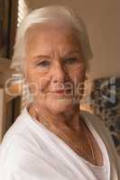 Happy senior woman relaxing in bedroom at home