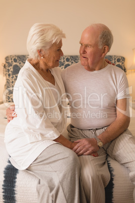 Senior couple looking at each other in bedroom