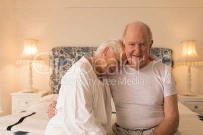 Senior couple relaxing in bedroom at home