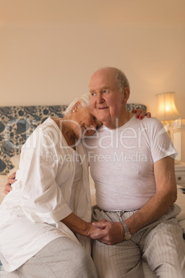 Senior couple relaxing in bedroom at home