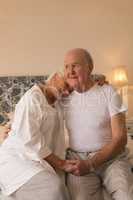 Senior couple relaxing in bedroom at home