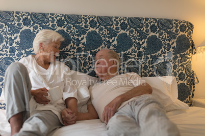 Senior couple interacting with each other in bedroom