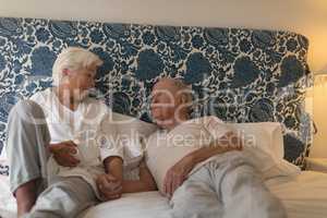Senior couple interacting with each other in bedroom