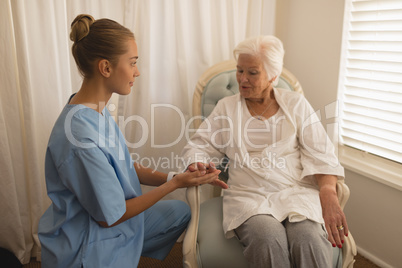 Female physician consoling senior woman
