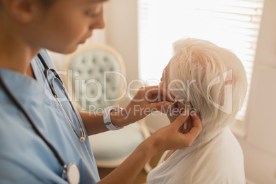 Female physician caring for senior woman