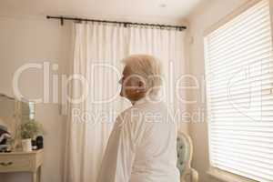 Senior woman relaxing in bedroom