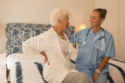 Senior woman interacting with female doctor