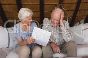 Worried senior couple discussing over medical bills