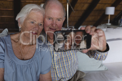 Senior couple taking selfie with mobile phone