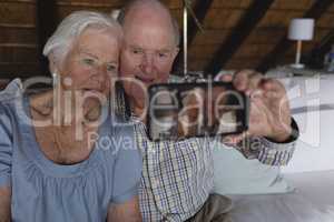 Senior couple taking selfie with mobile phone