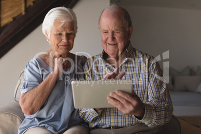 Senior couple using digital tablet