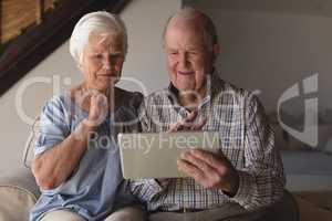 Senior couple using digital tablet