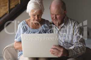 Senior couple using laptop