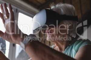 Senior woman using virtual reality headset