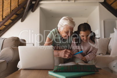 Grandmother helping her granddaughter with homework