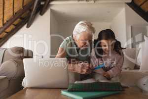 Grandmother helping her granddaughter with homework