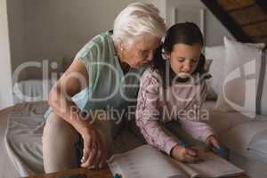 Grandmother helping her granddaughter with homework