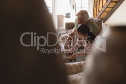 Grandmother helping her granddaughter with homework