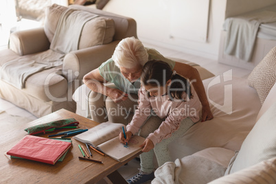 Grandmother helping her granddaughter with homework