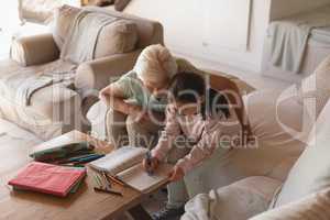 Grandmother helping her granddaughter with homework