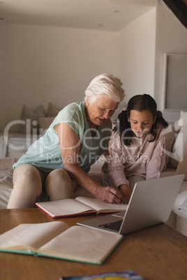 Grandmother helping her granddaughter with homework