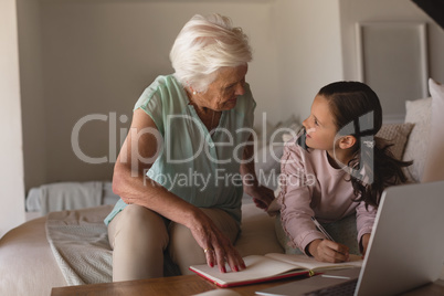 Grandmother helping her granddaughter with homework