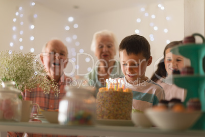 Multi-generation family celebrating birthday of grandson