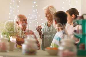 Multi-generation family celebrating birthday at home