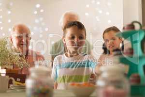 Multi-generation family celebrating birthday of grandson at home