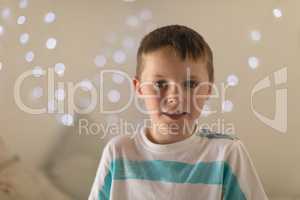 Innocent boy sitting in bedroom at home