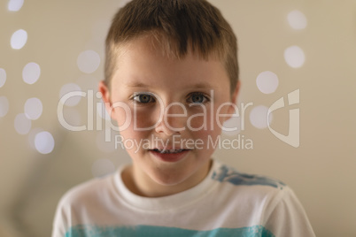 Innocent boy sitting in bedroom at home