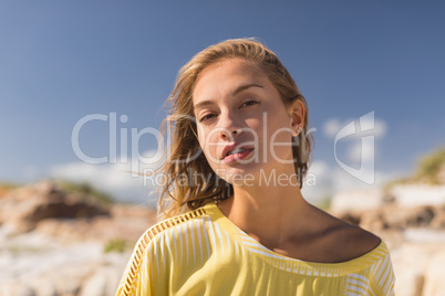 Beautiful woman standing at beach on a sunny day