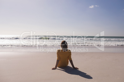Woman relaxing and looking at view on the beach