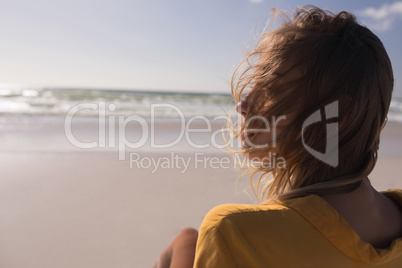 Young woman relaxing at beach on a sunny day