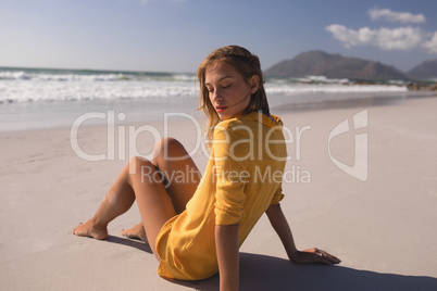 Young woman relaxing at beach on a sunny day