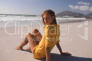 Young woman relaxing at beach on a sunny day