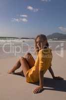 Young woman relaxing at beach on a sunny day