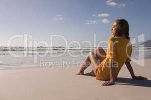 Young woman relaxing with eyes closed at beach