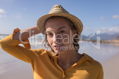 Woman in hat standing on the beach